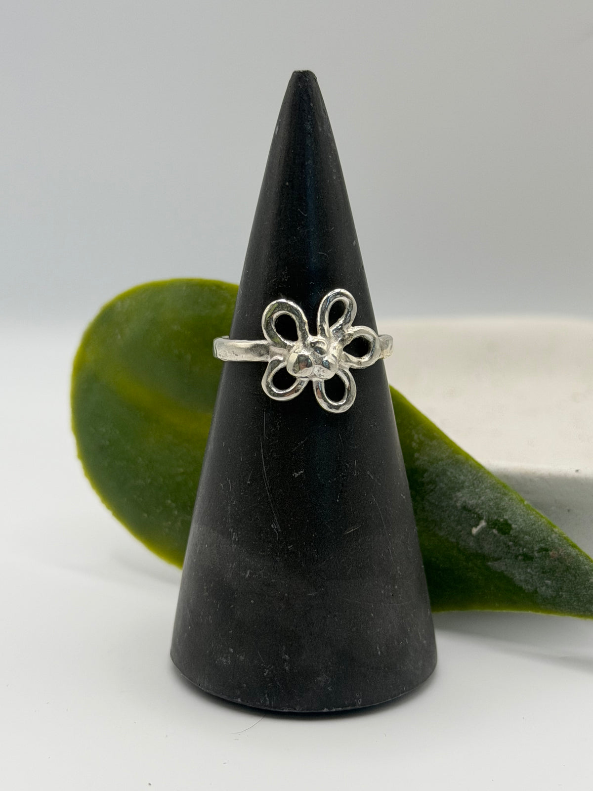 Handcrafted sterling silver flower ring featuring an open petal design and textured centre, handcrafted in Lincolnshire