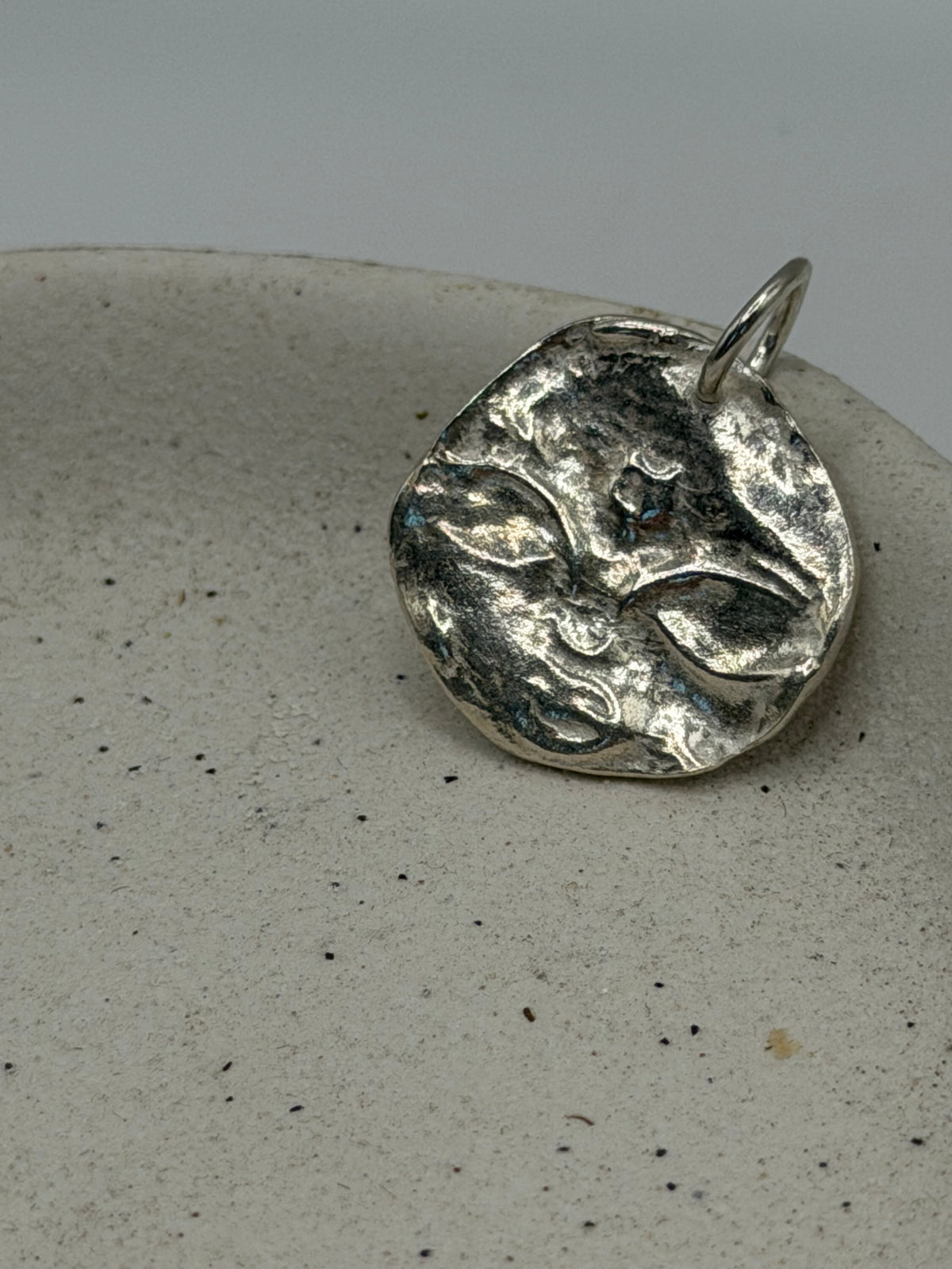 Handmade fine silver Love Lock charm featuring a handstamped boho full moon design on a delicate, textured silver disc, finished with a beaded detail across the top.