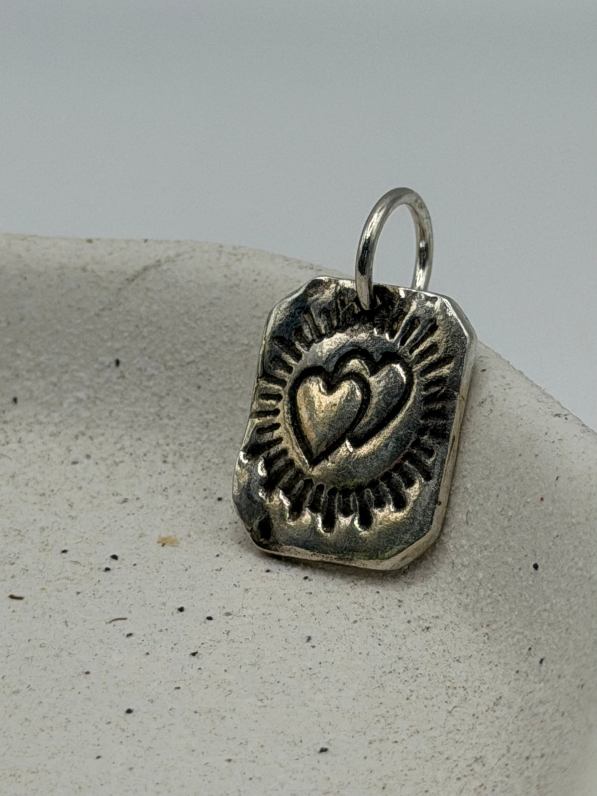 Handmade fine silver Love Lock charm featuring an organic, textured disc with a handstamped tarot card-inspired design and a row of beaded silver detail.