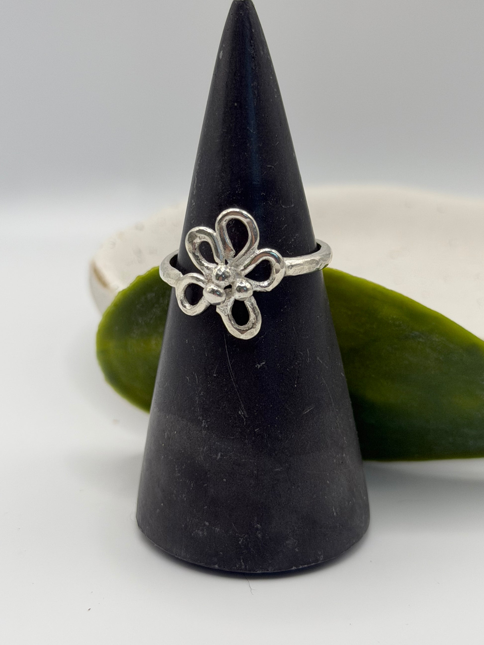 Handcrafted sterling silver flower ring featuring an open petal design and textured centre, handcrafted in Lincolnshire