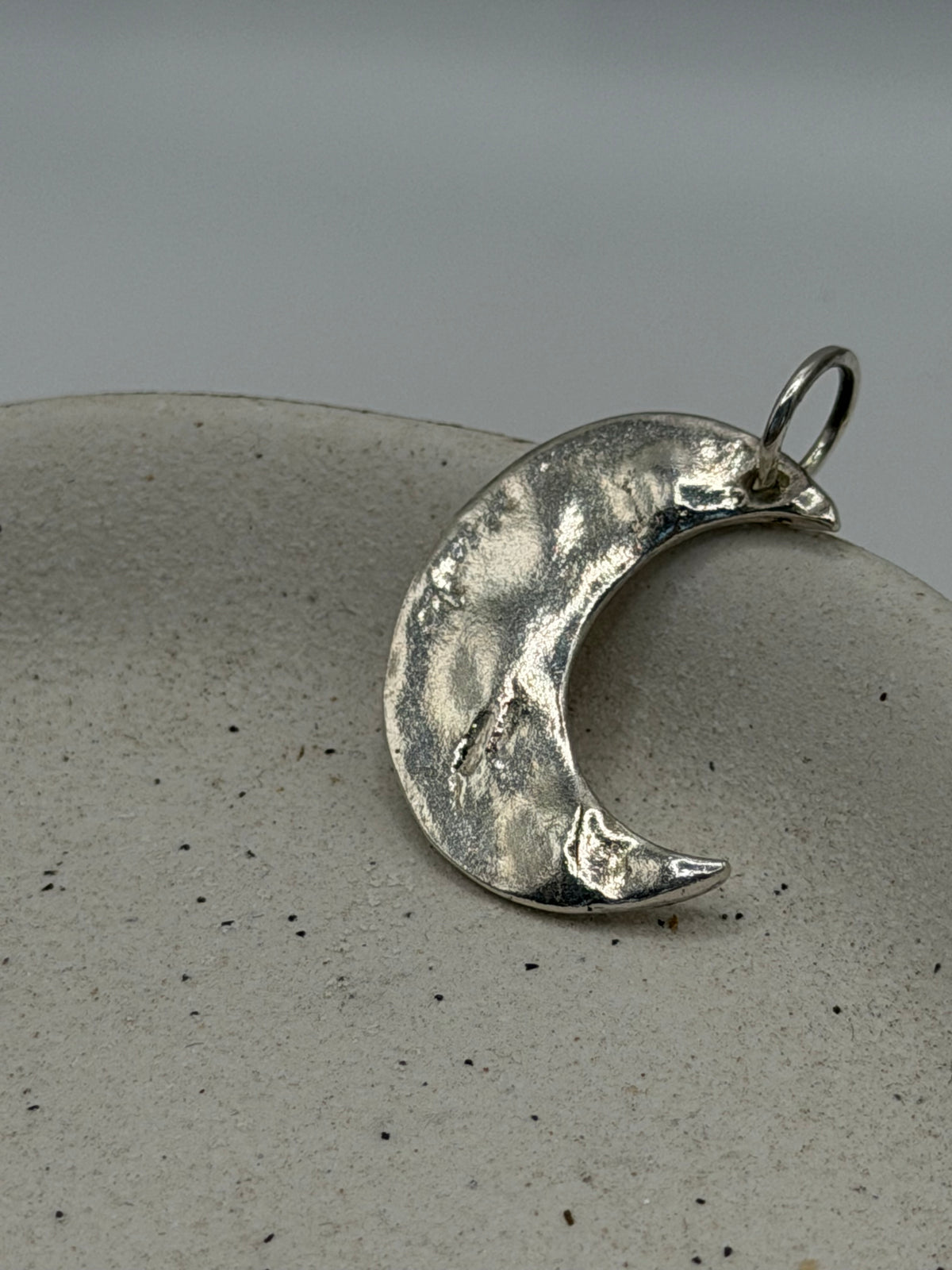 Handmade fine silver Maxi Crescent Moon charm with an organic, textured crescent moon design, available with a belcher chain from Wild One Jewellery\.