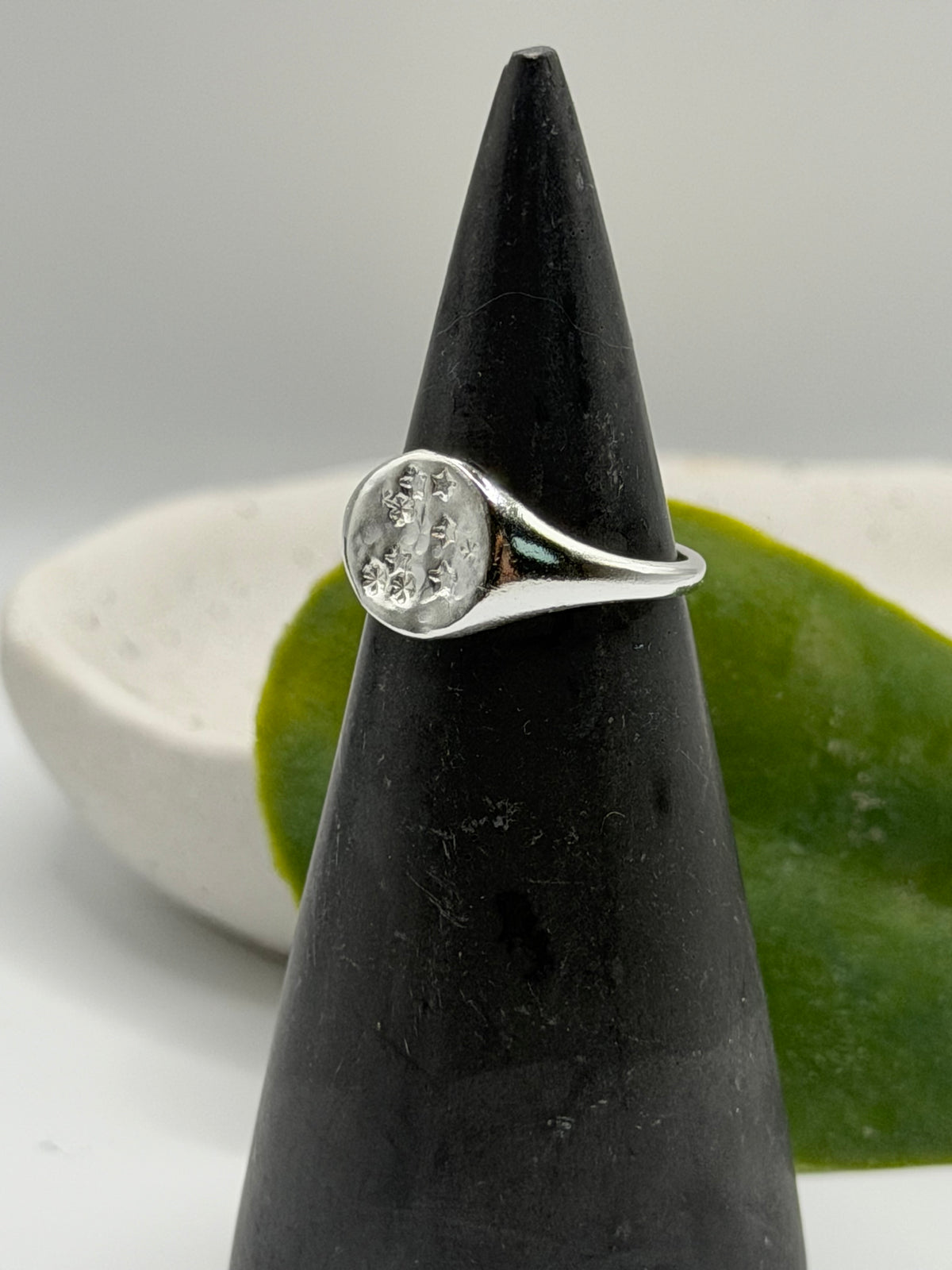 Handmade recycled sterling silver Galaxy Signet Ring featuring a circular dimple-textured face with tiny scattered star details, crafted in small batches by independent silversmith Wild One Jewellery in Lincolnshire, UK.