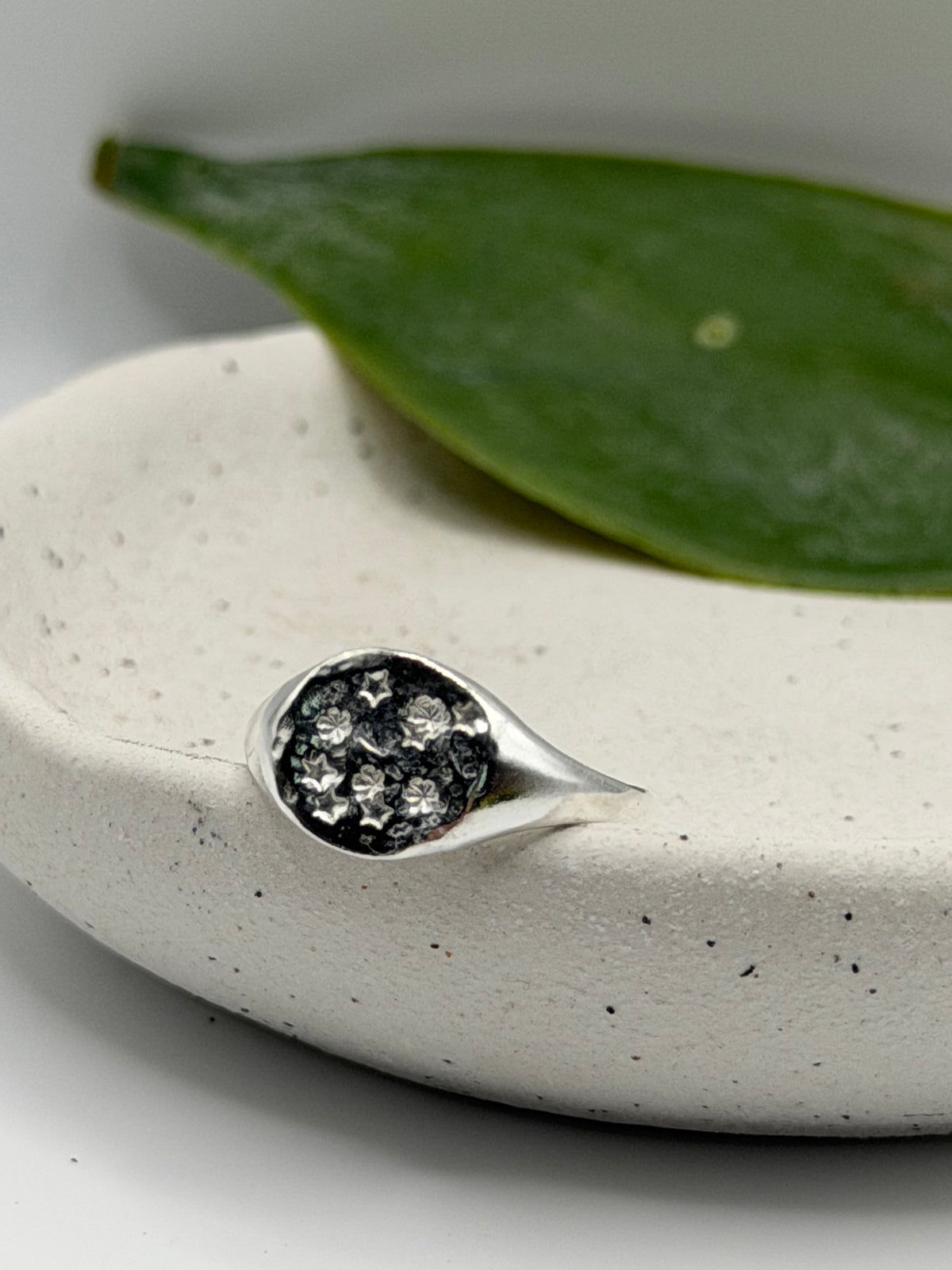 Handmade recycled sterling silver Galaxy Signet Ring featuring a circular dimple-textured face with tiny scattered star details, crafted in small batches by independent silversmith Wild One Jewellery in Lincolnshire, UK.