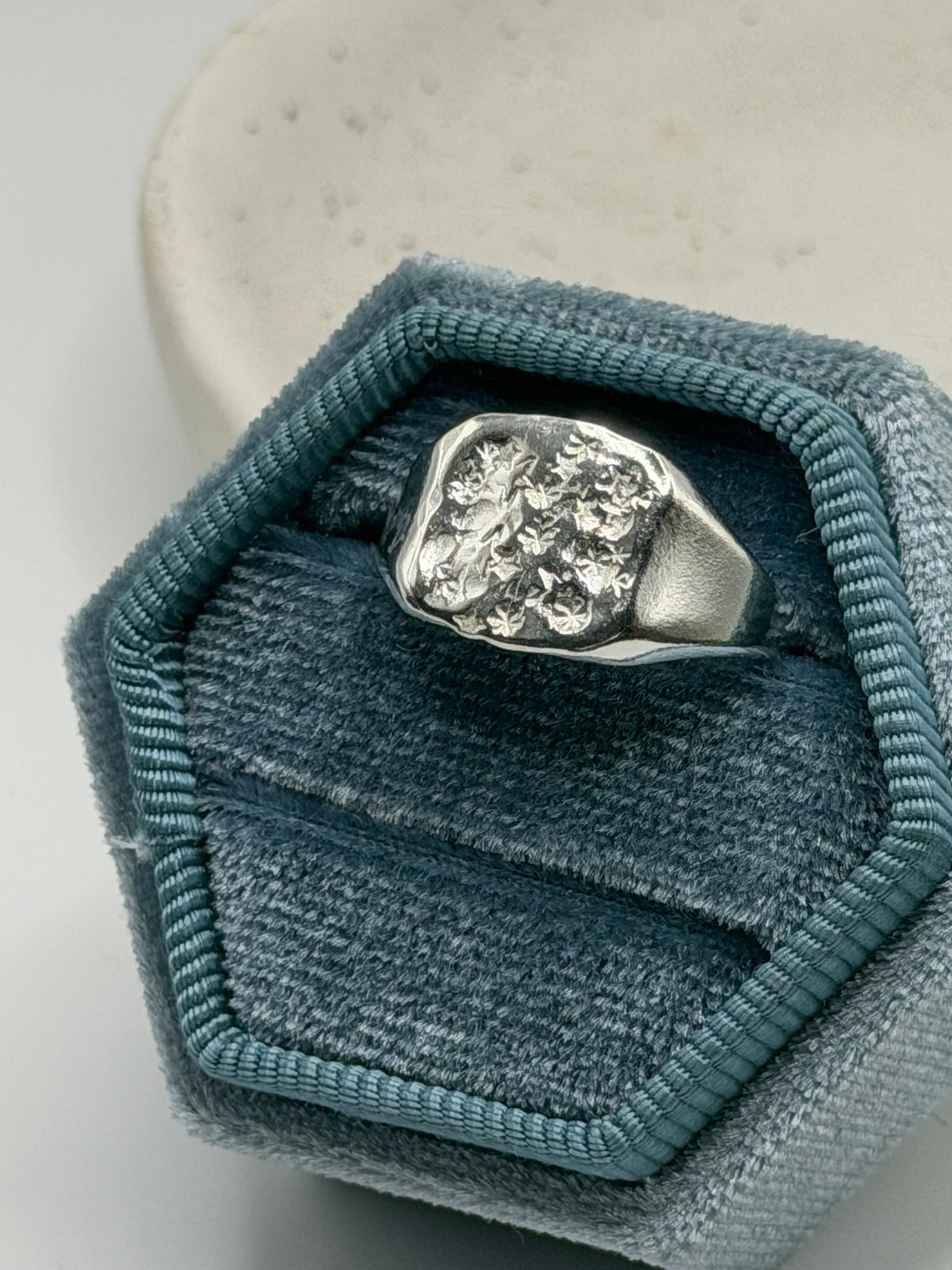 Handmade recycled sterling silver Galaxy Signet Ring featuring a circular dimple-textured face with tiny scattered star details, crafted in small batches by independent silversmith Wild One Jewellery in Lincolnshire, UK.