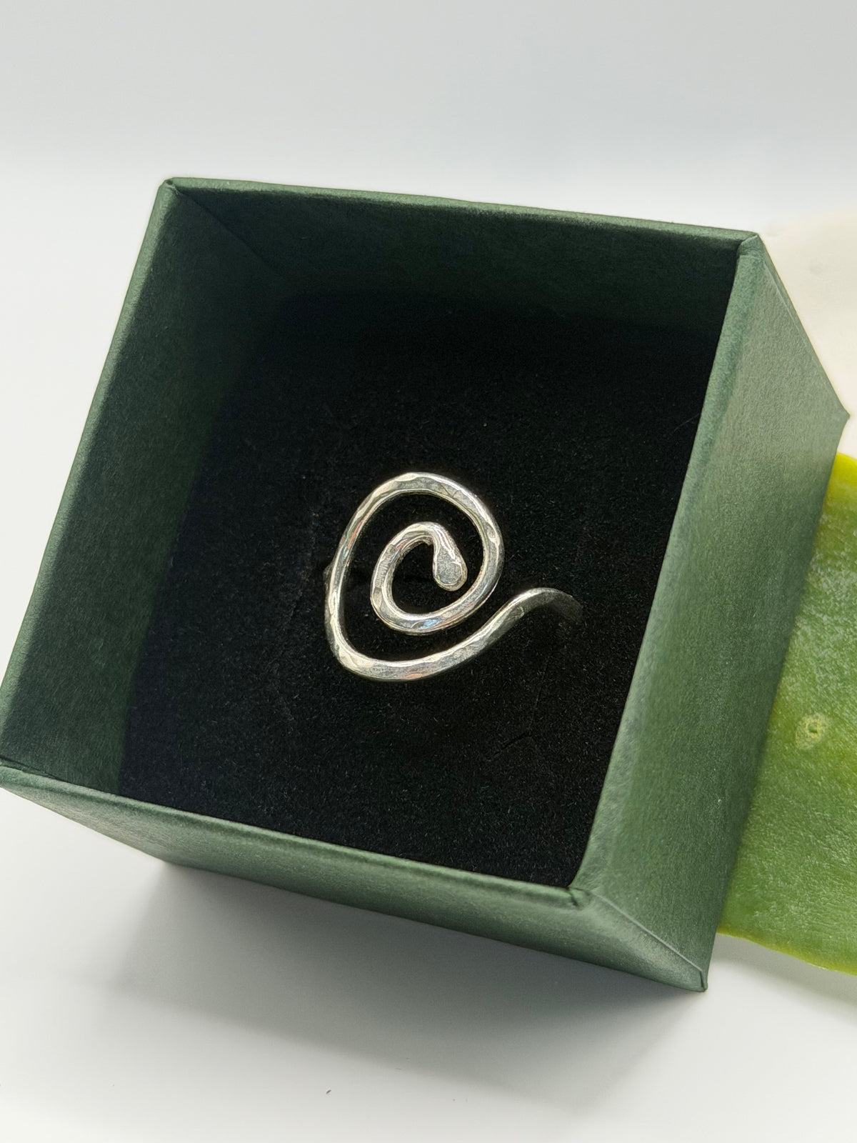 Handmade recycled sterling silver spiral ring with an organic swirl design and polished textured finish by Wild One Jewellery, Lincolnshire.