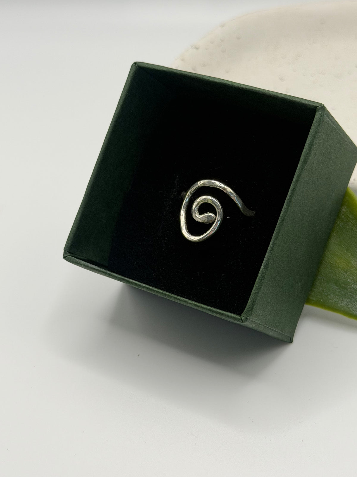 Handmade recycled sterling silver spiral ring with an organic swirl design and polished textured finish by Wild One Jewellery, Lincolnshire.