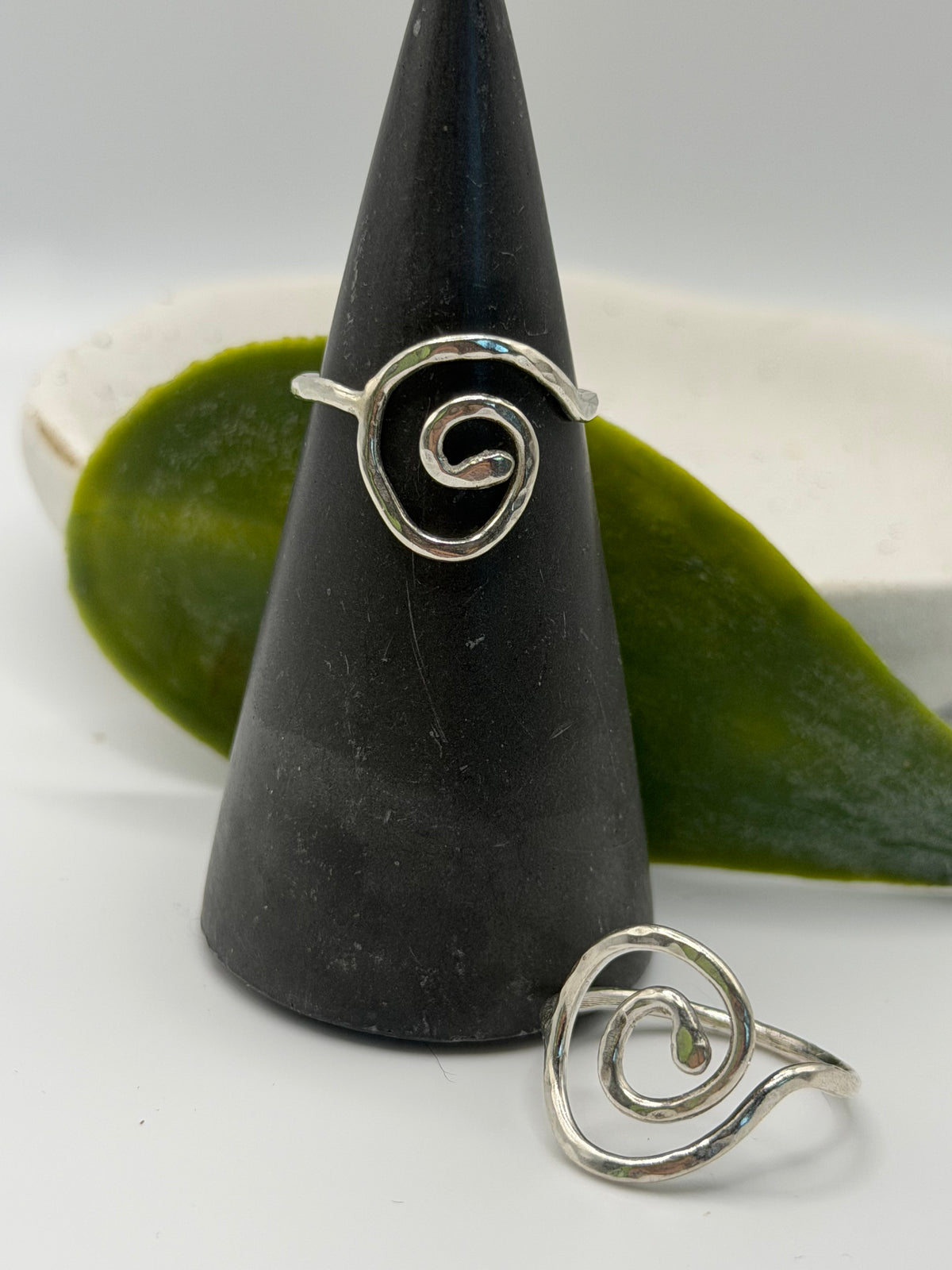 Handmade recycled sterling silver spiral ring with an organic swirl design and polished textured finish by Wild One Jewellery, Lincolnshire.