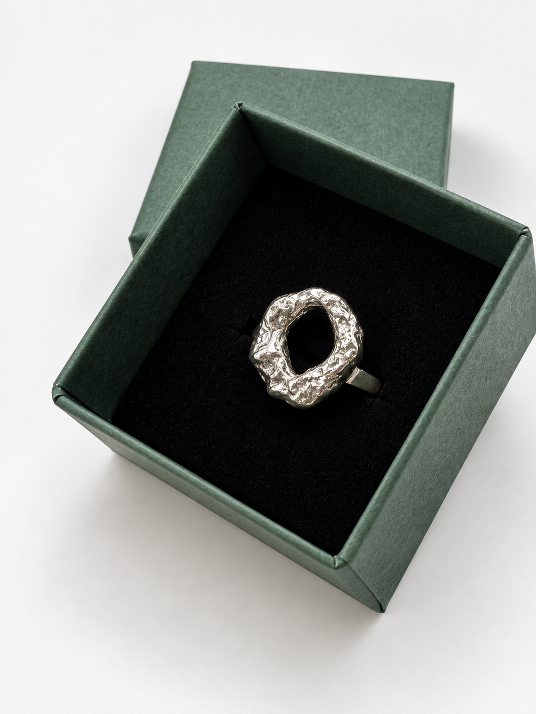 Handmade chunky Molten Circle ring crafted from recycled sterling silver, with an irregular lava-like texture created by melting the silver and quenching it in water to freeze its organic shape. Wild One Jewellery.