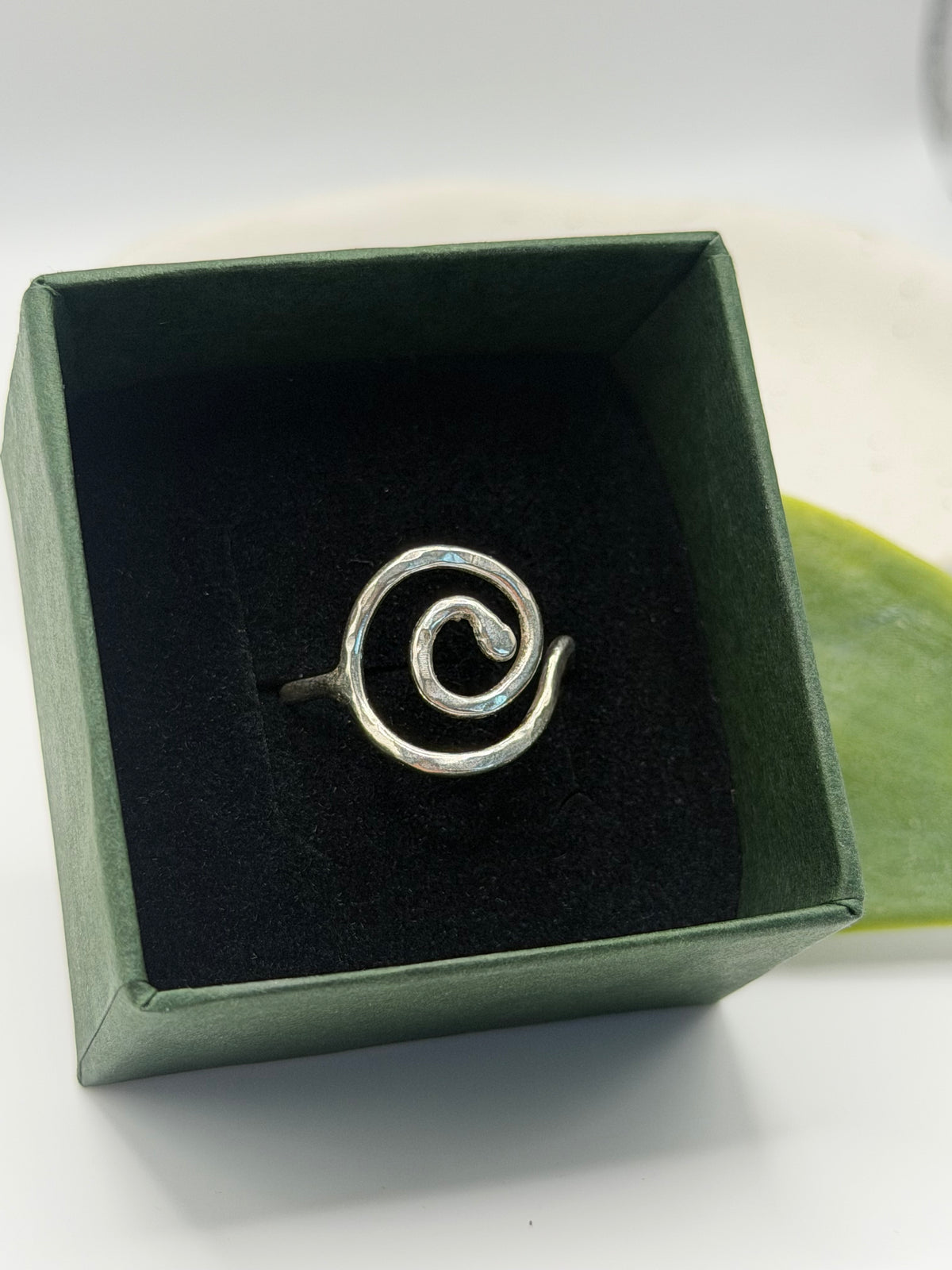 Handmade recycled sterling silver spiral ring with an organic swirl design and polished textured finish by Wild One Jewellery, Lincolnshire.