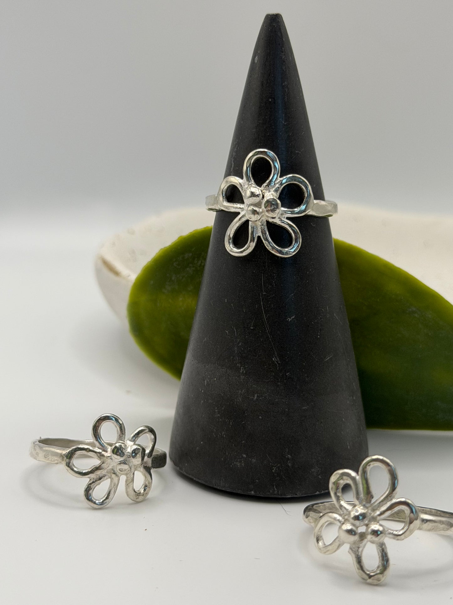 Handcrafted sterling silver flower ring featuring an open petal design and textured centre, handcrafted in Lincolnshire 