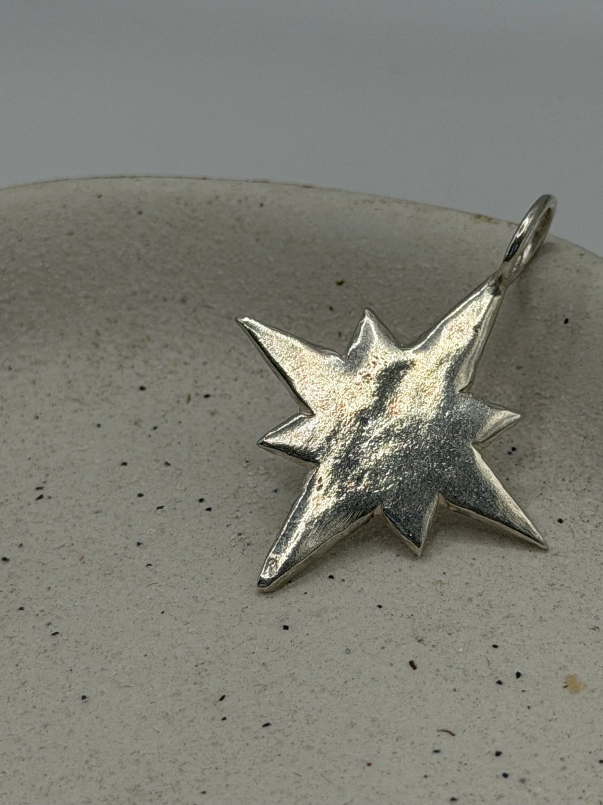 Handmade fine silver Maxi Pole Star charm with an organic, textured star design, available with a belcher chain from Wild One Jewellery\.