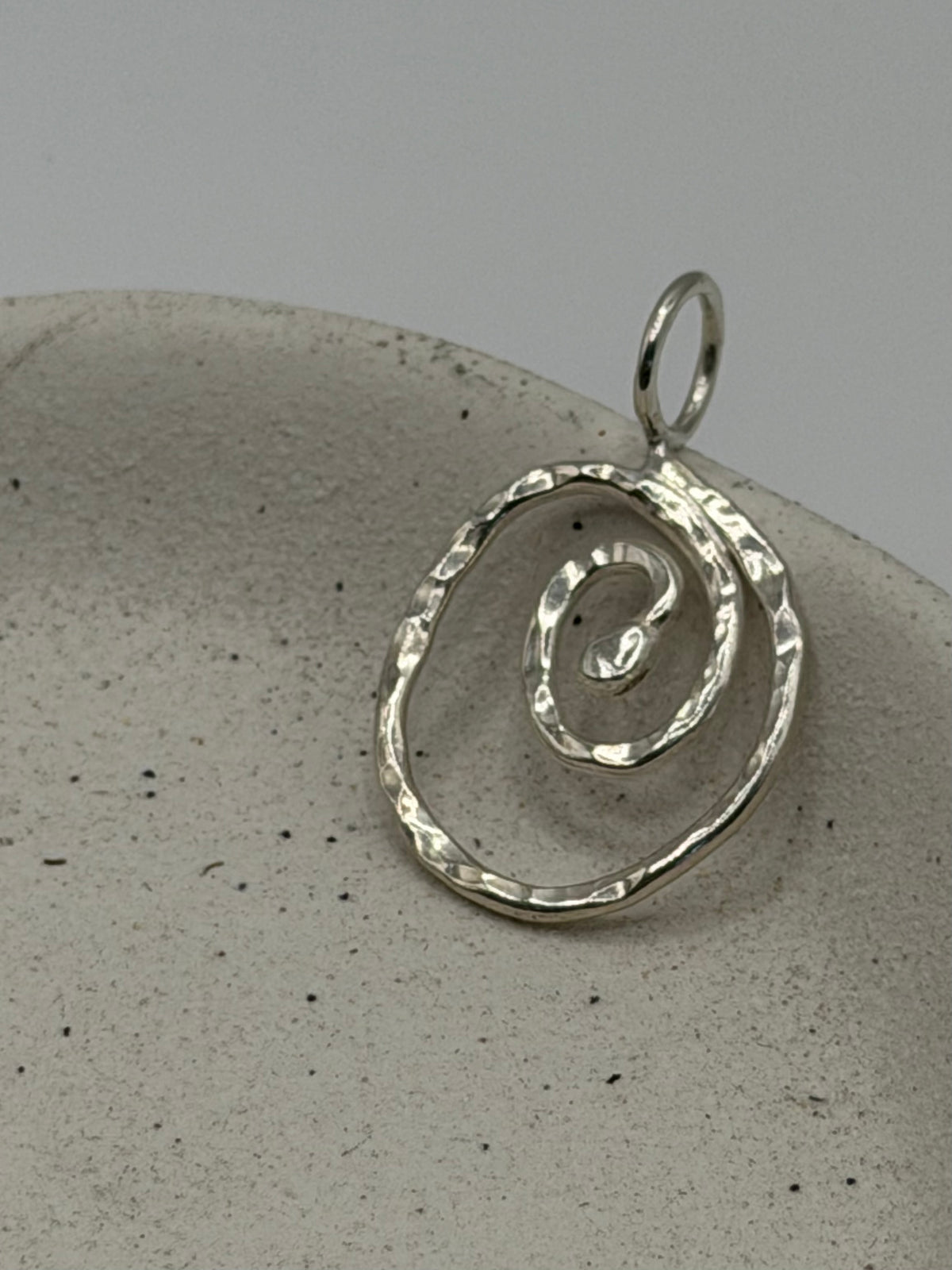 Handmade fine silver Spiral charm with an organic, textured spiral design, available with a belcher chain from Wild One Jewellery.