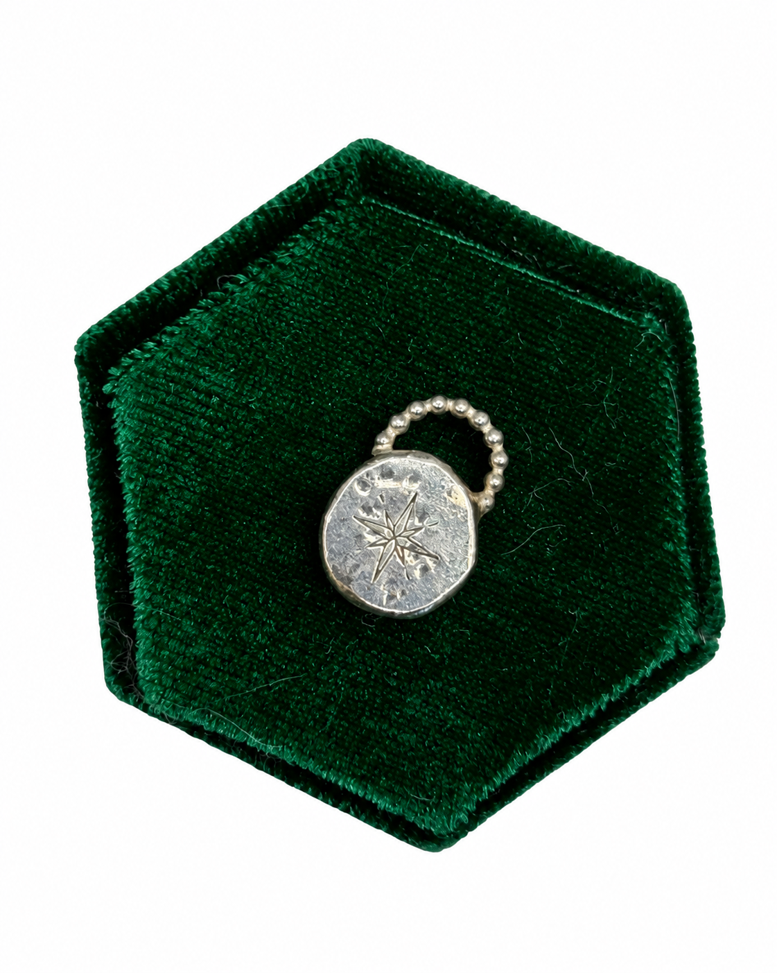 Handmade recycled sterling silver Love Lock charm featuring a handstamped guiding star inspired by a compass on a chunky organic disc, finished with a row of beaded silver detail\.
