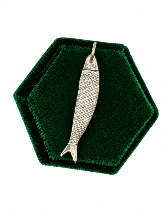 Handmade maxi fish charm crafted from 999 fine silver metal clay, featuring a detailed textured finish and organic shape, photographed on a dark green velvet jewellery display.