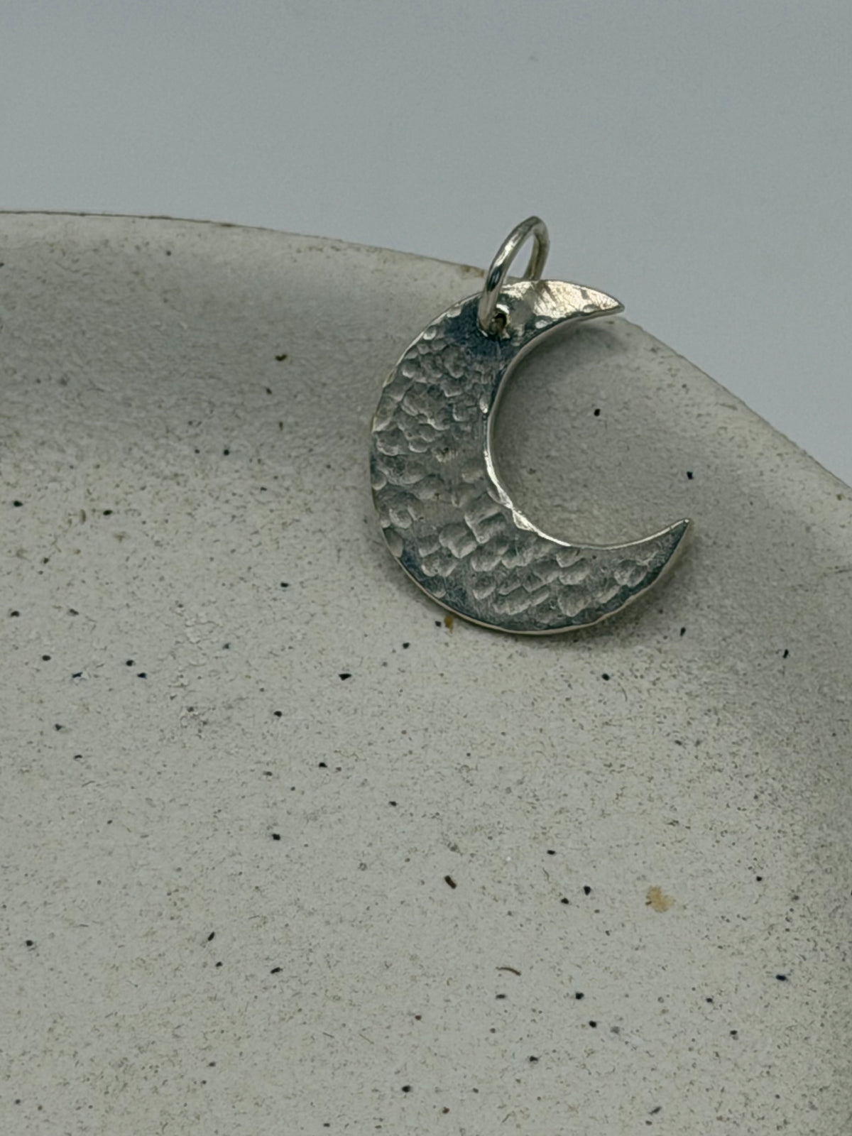 Handmade fine silver Love Lock charm featuring a handstamped moon design on a delicate, textured silver disc, finished with a beaded detail across the top\.