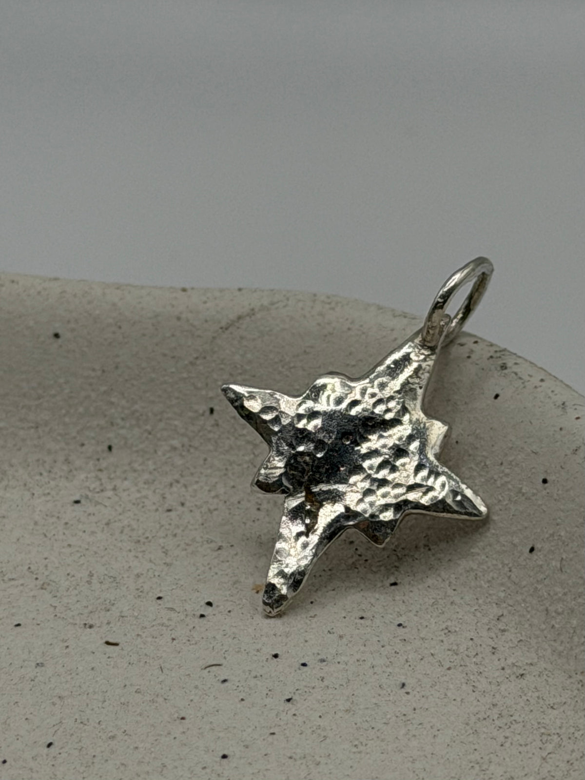 Handmade fine silver Midi Pole Star charm featuring a handstamped north star design on a delicate, textured silver disc, finished with a beaded detail across the top.