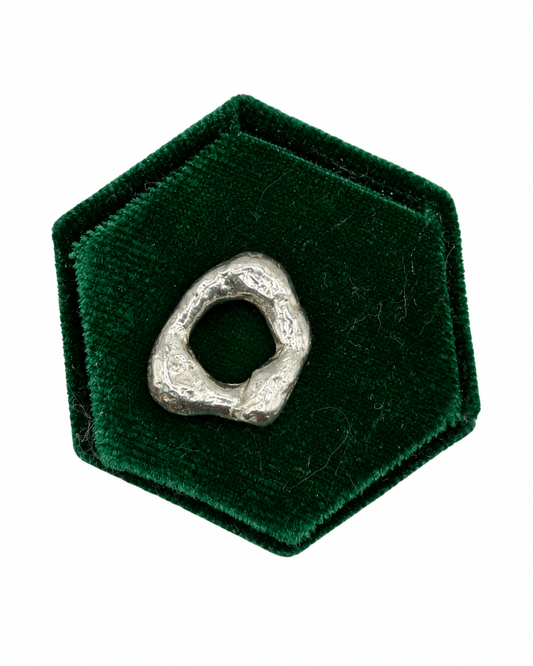 Molten No. 05 handmade recycled sterling silver charm by Wild One Jewellery, featuring a unique organic shape and raw lava-like texture created by melting and quenching silver.