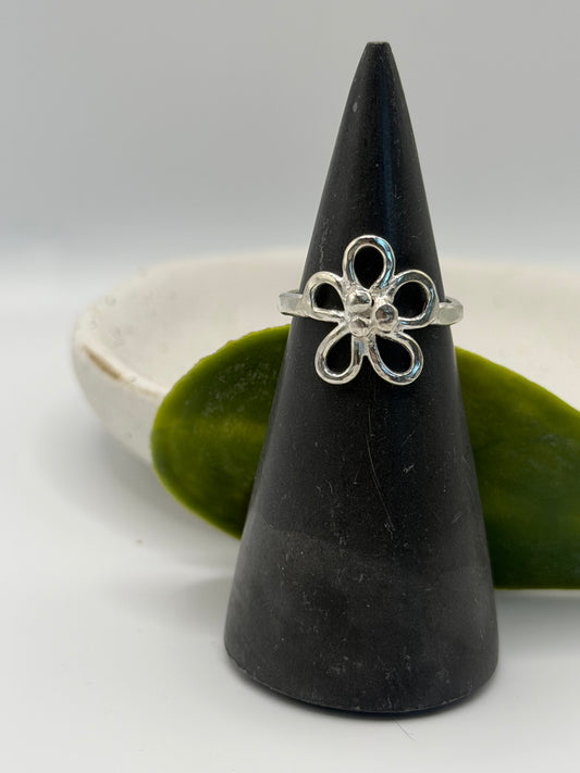 Handcrafted sterling silver flower ring featuring an open petal design and textured centre, handcrafted in Lincolnshire