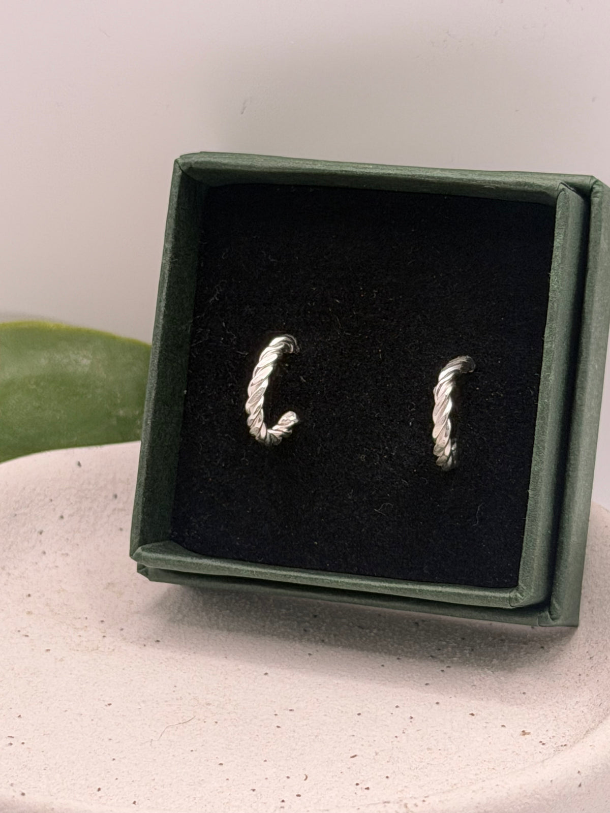 Recycled 925 sterling silver rope hoop earrings with butterfly scroll fastenings, featuring a twisted design handmade by Wild One Jewellery in green branded box 
