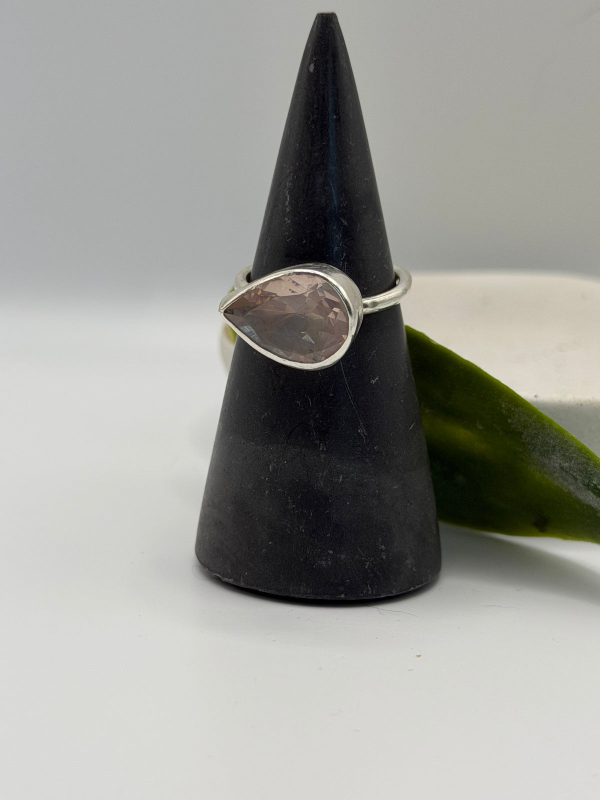 Image alt text: One-of-a-kind statement rose quartz ring from the Stone + Silver collection, featuring a large faceted blush-pink gemstone set in a sterling silver band.