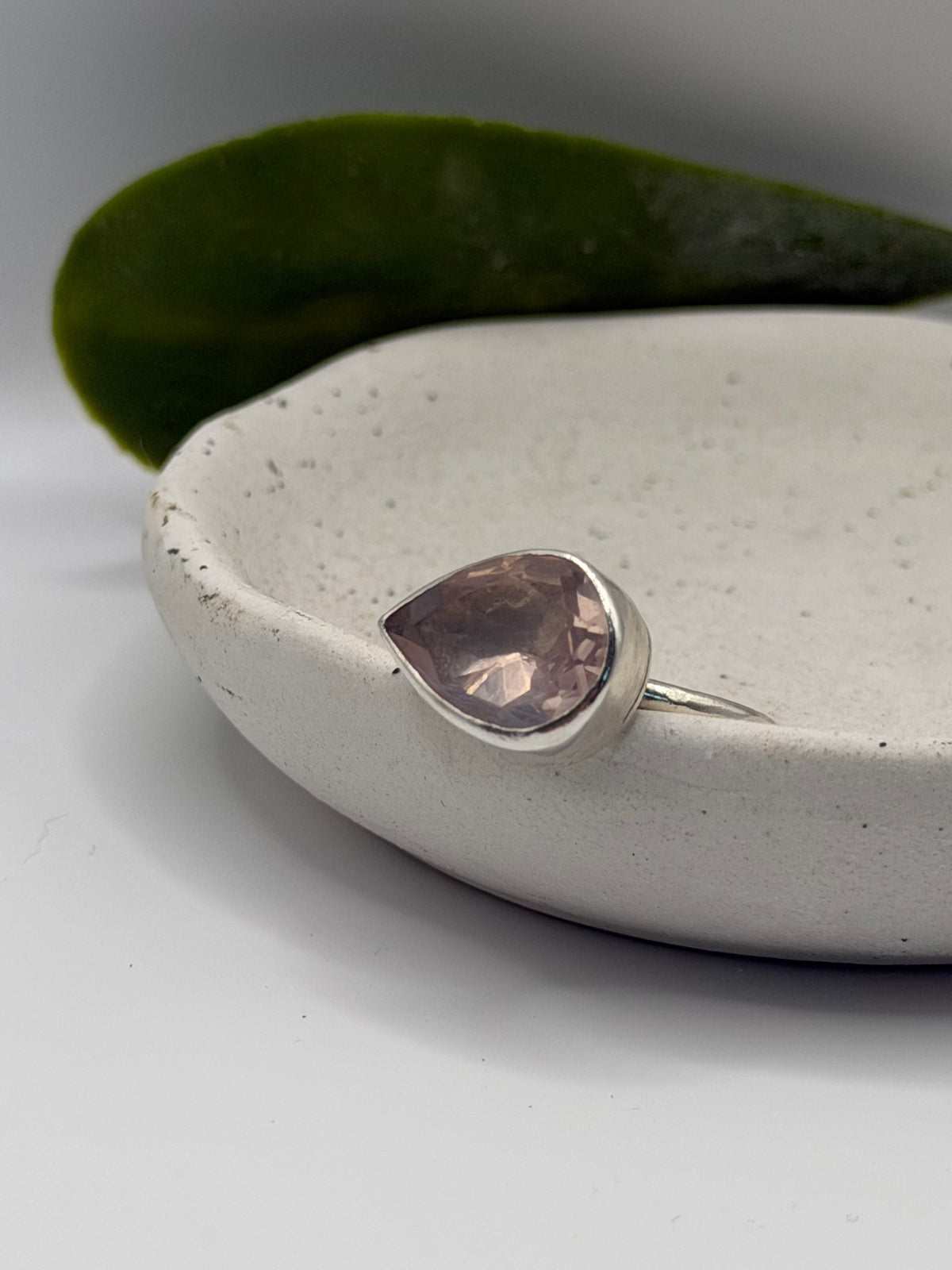 Image alt text: One-of-a-kind statement rose quartz ring from the Stone + Silver collection, featuring a large faceted blush-pink gemstone set in a sterling silver band.
