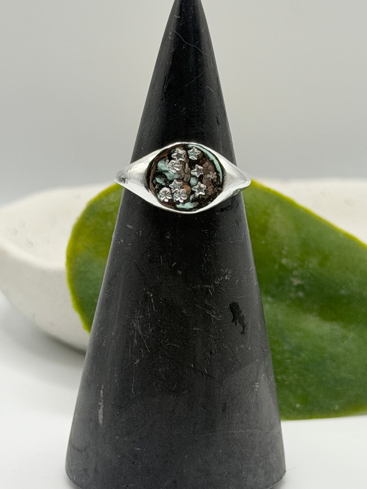 Handmade recycled sterling silver Galaxy Signet Ring featuring a circular dimple-textured face with tiny scattered star details, crafted in small batches by independent silversmith Wild One Jewellery in Lincolnshire, UK.