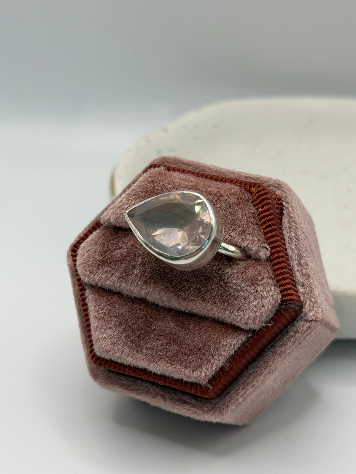 Image alt text: One-of-a-kind statement rose quartz ring from the Stone + Silver collection, featuring a large faceted blush-pink gemstone set in a sterling silver band.