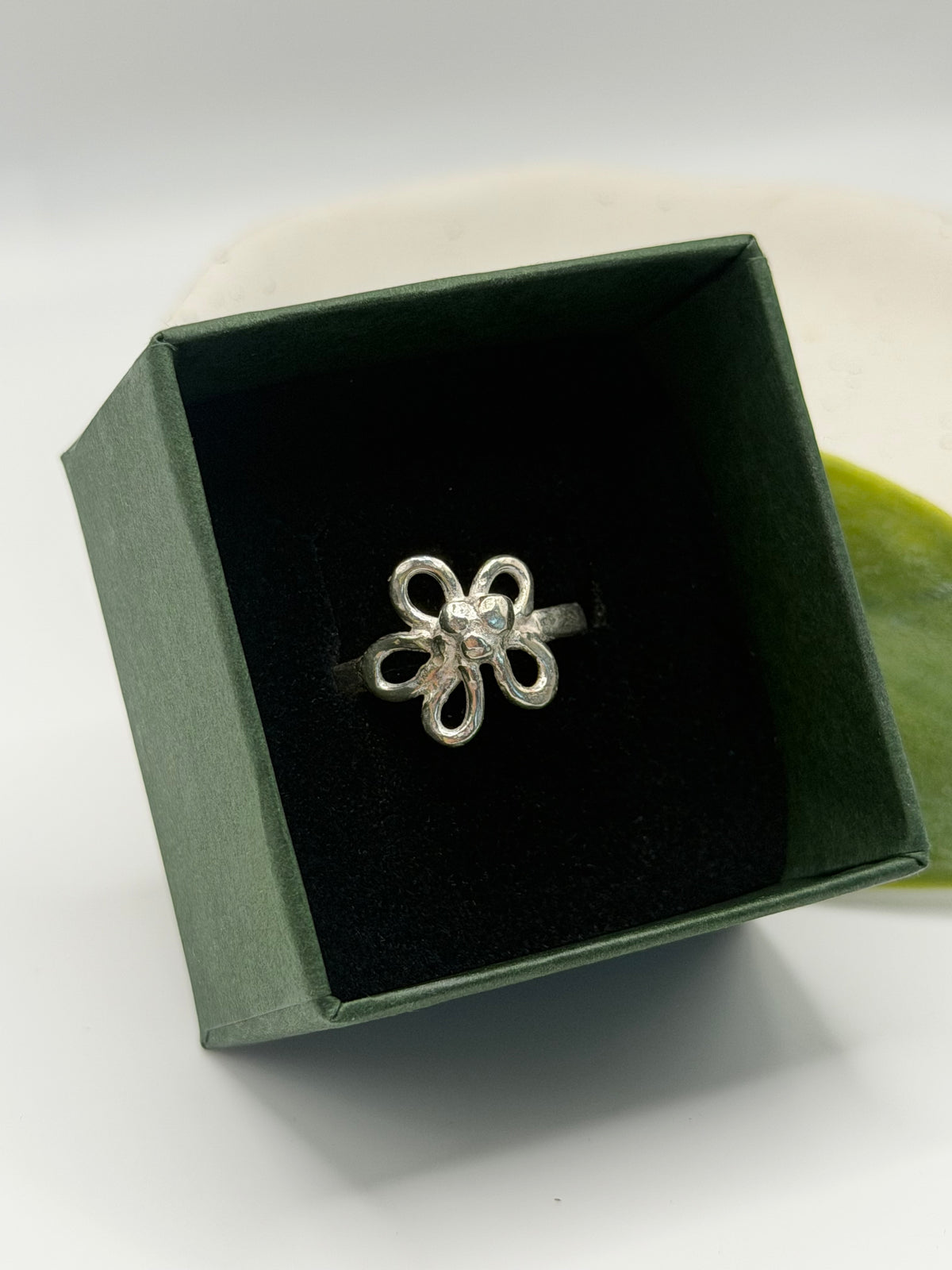 Handcrafted sterling silver flower ring featuring an open petal design and textured centre, handcrafted in Lincolnshire