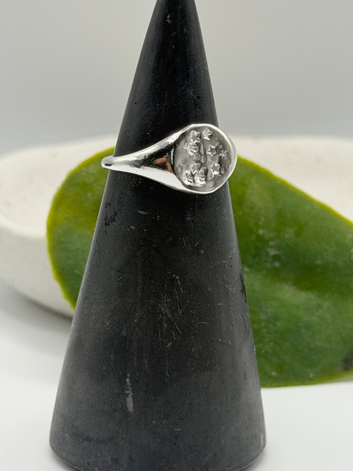 Handmade recycled sterling silver Galaxy Signet Ring featuring a circular dimple-textured face with tiny scattered star details, crafted in small batches by independent silversmith Wild One Jewellery in Lincolnshire, UK.