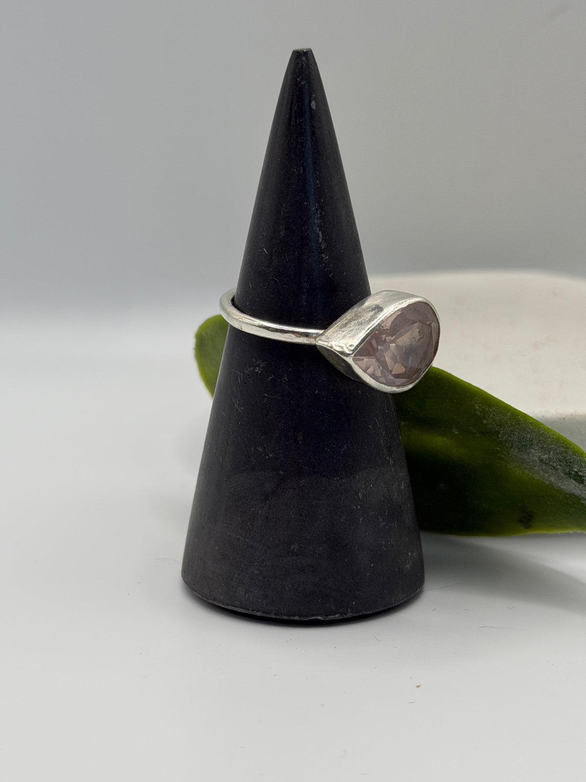 Image alt text: One-of-a-kind statement rose quartz ring from the Stone + Silver collection, featuring a large faceted blush-pink gemstone set in a sterling silver band.