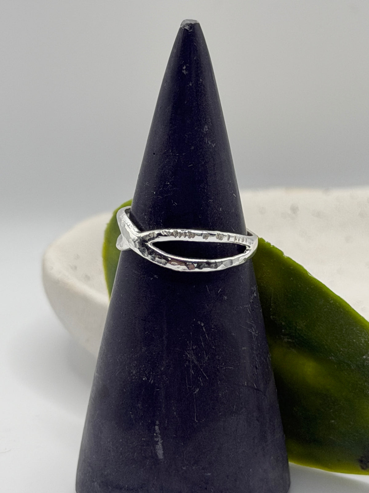 Handmade recycled sterling silver Twist Ring with an organic crossover design and contrasting hammered and linear textures, created in small batches by independent silversmith Wild One Jewellery in Lincolnshire, UK.