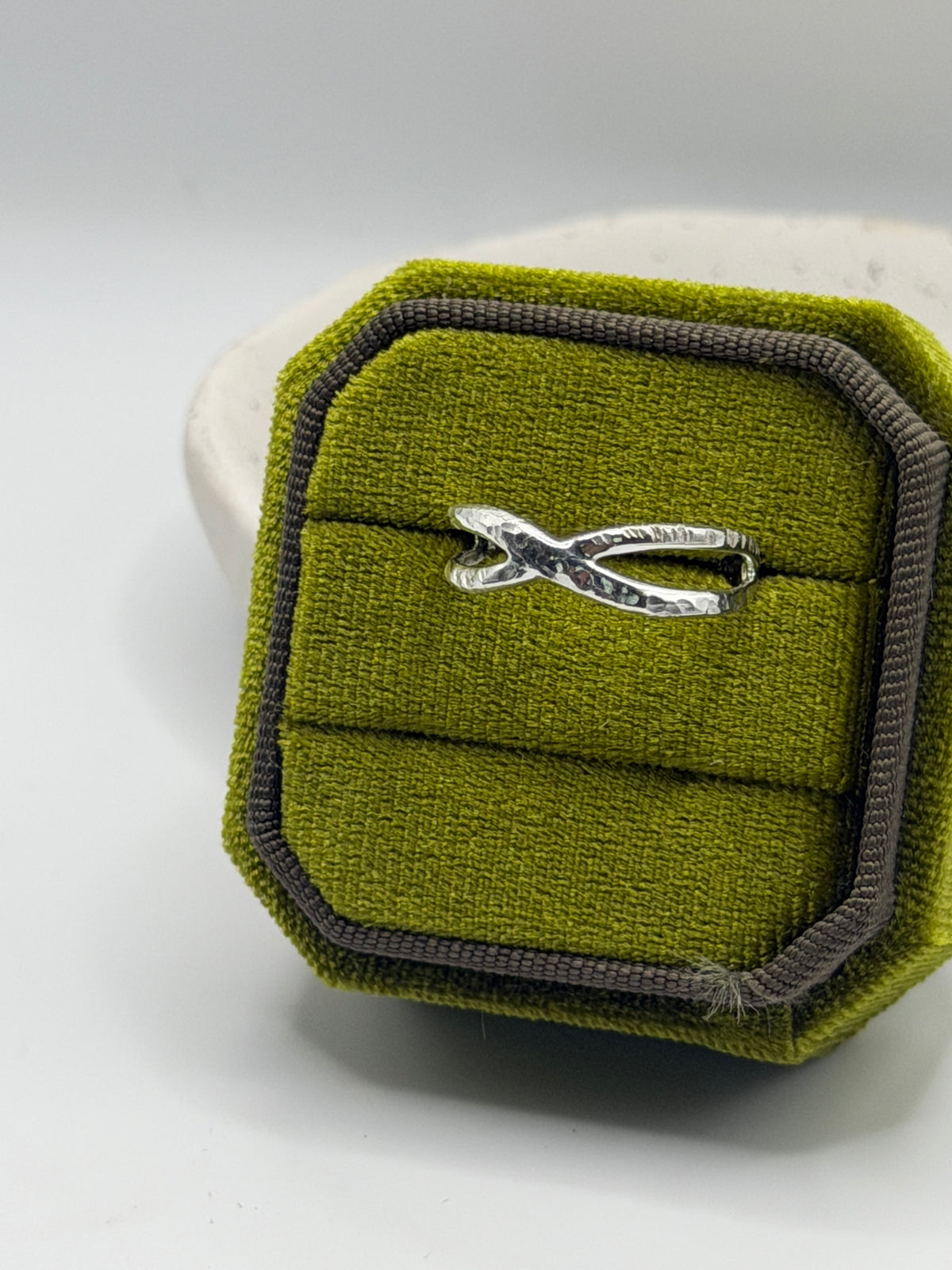 Handmade recycled sterling silver Twist Ring featuring an interwoven crossover design with contrasting hammered and linear textures, by Wild One Jewellery, an independent silversmith based in Lincolnshire, UK.